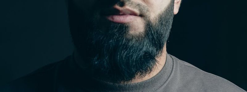 Silhouette of a man in a power pose against a dark background.